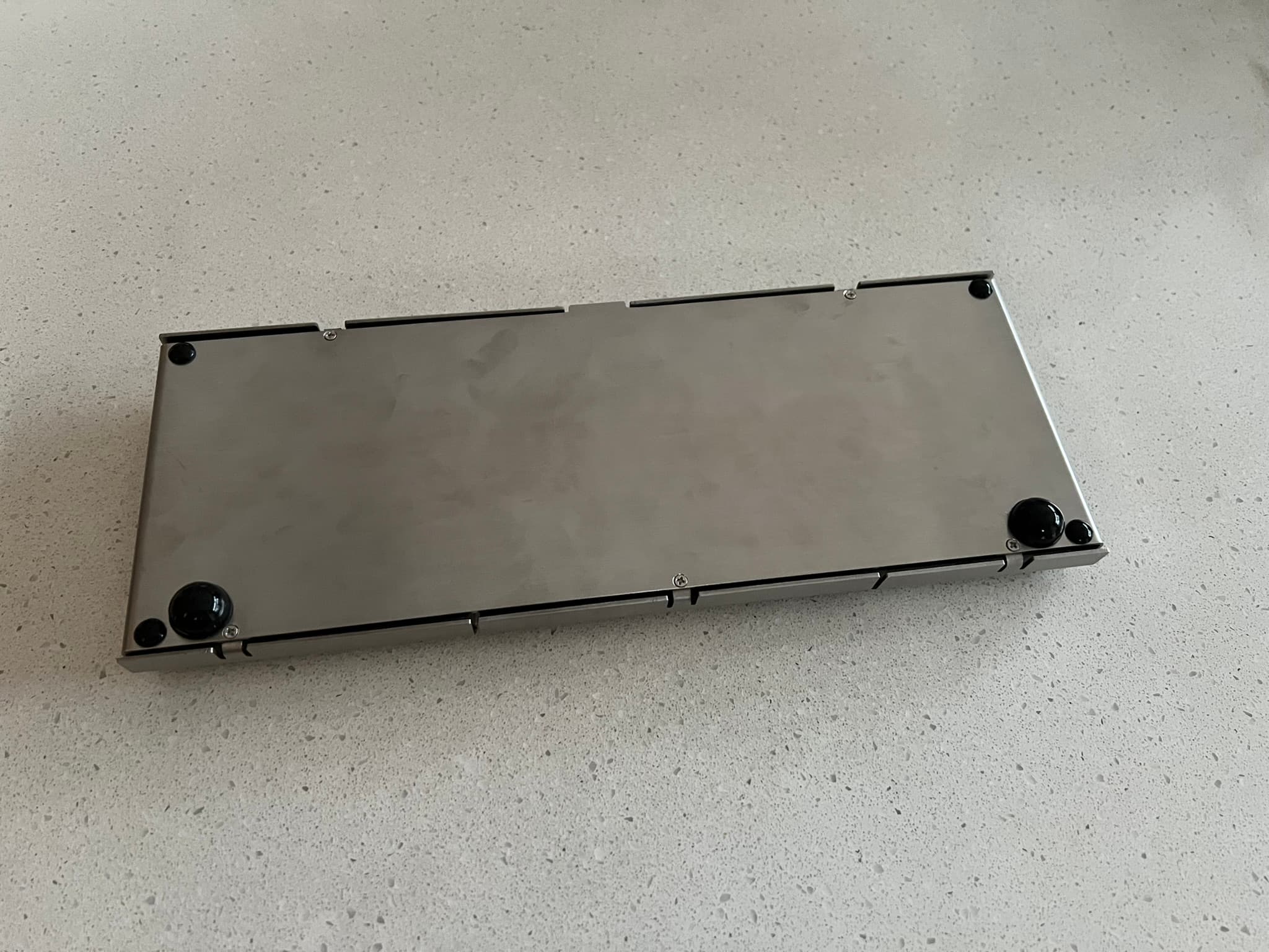 Bottom plate with 4 small feet installed and 2 large feet installed on the front corners