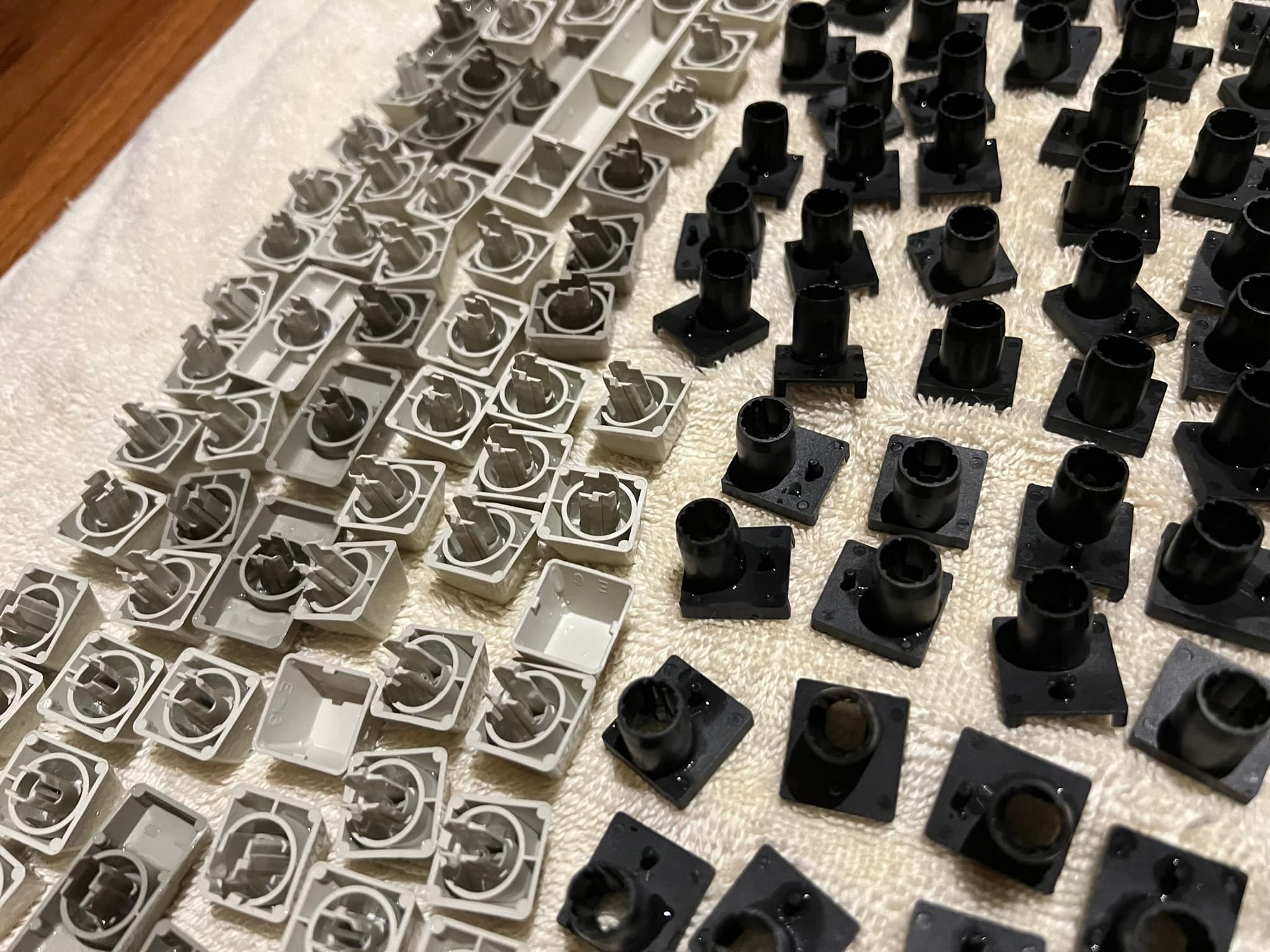 Wet keycaps and barrels laid out on a towel