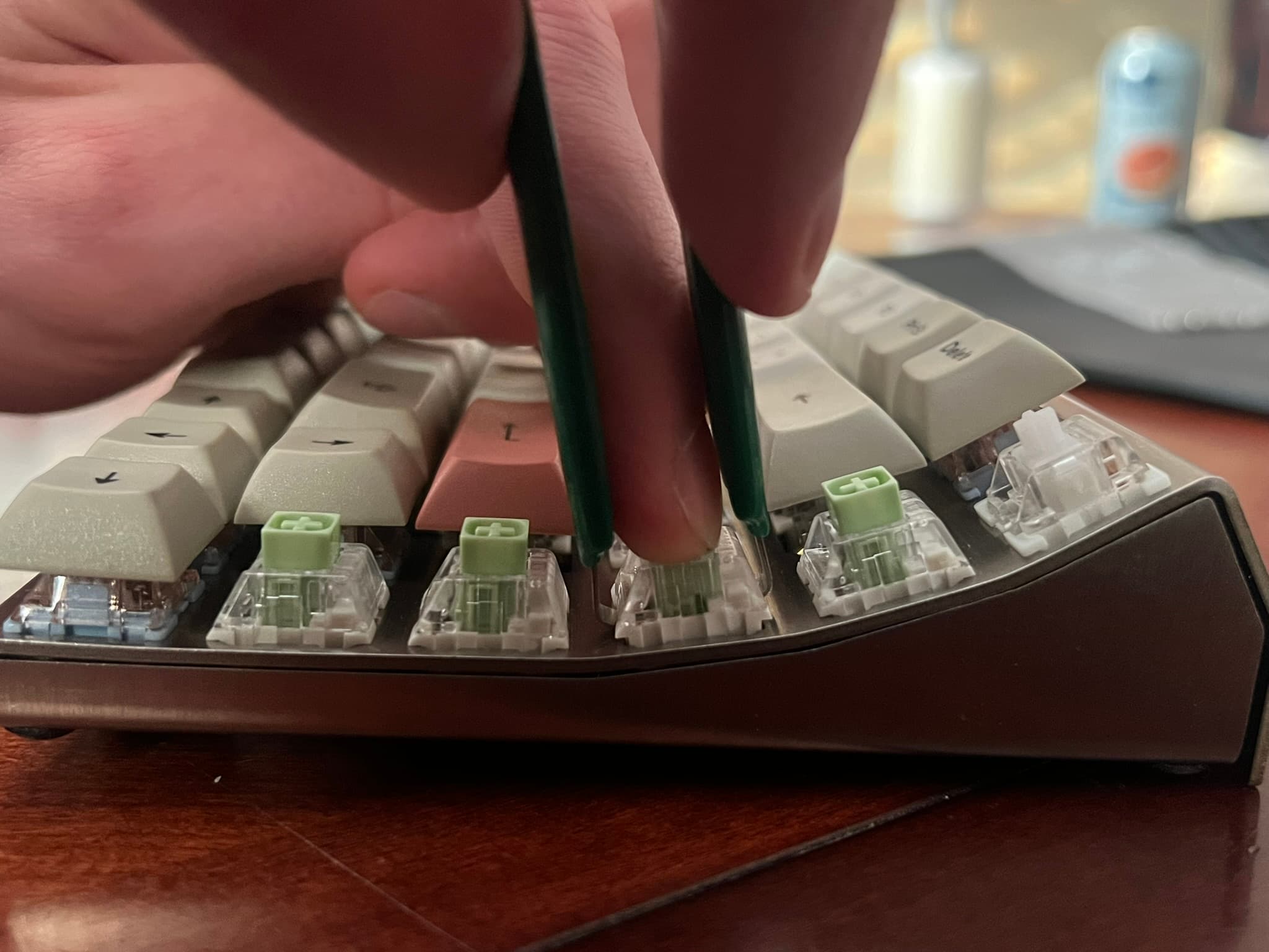A switch getting pushed by a finger while the tabs are compressed by a switch puller