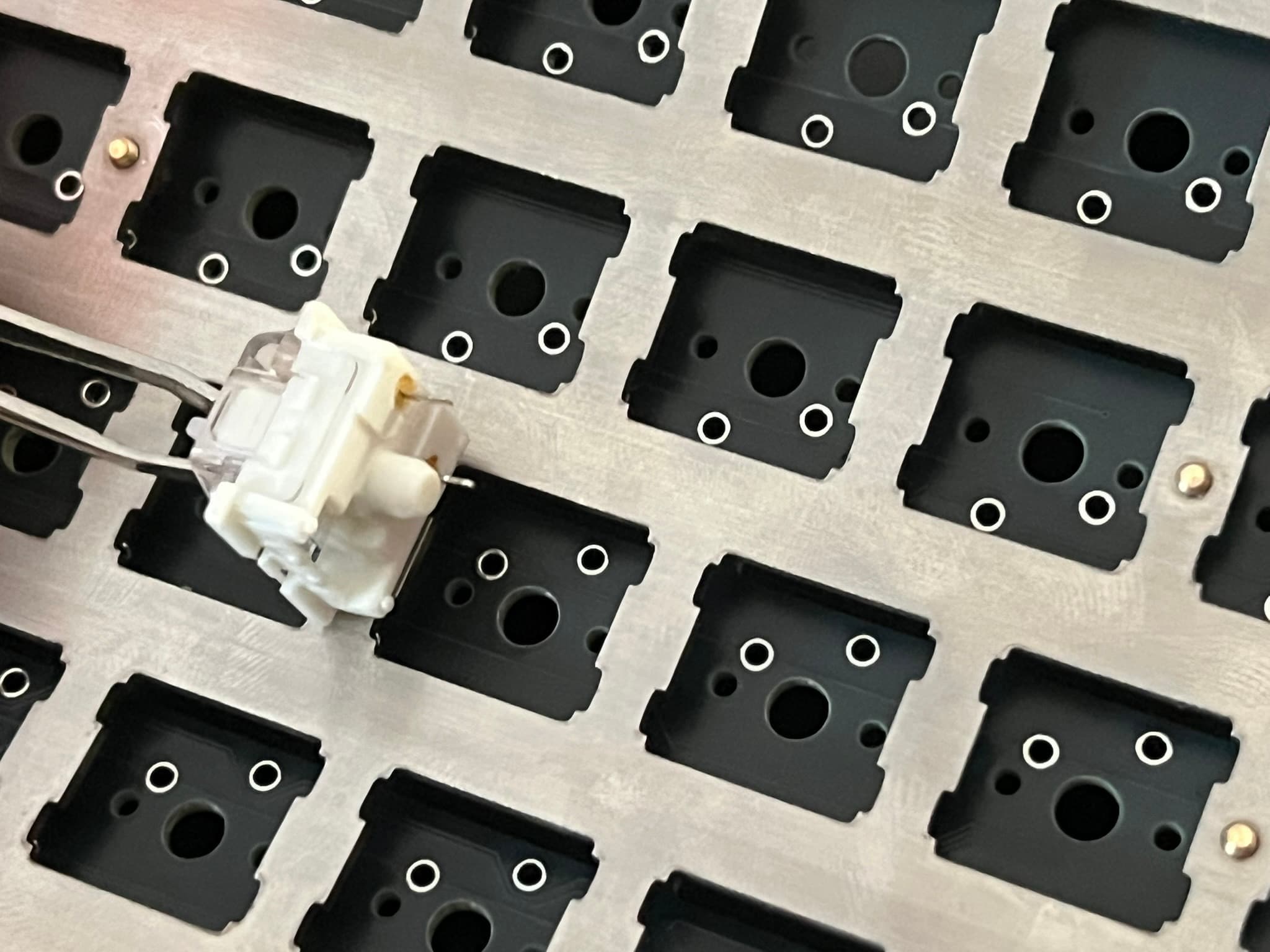 A switch above a plate and PCB